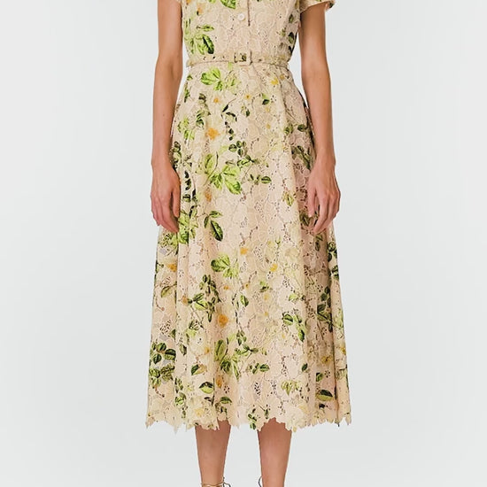 Monique Lhuillier Spring 2025 Rose printed lace shirt dress with short sleeves, button front bodice, self-fabric belt at waist and midi length skirt - video.