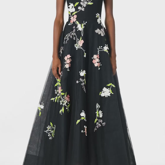 Monique Lhuillier Spring 2025 Sleeveless, noir tulle gown with floral embroidery and slight high-low hem - video.