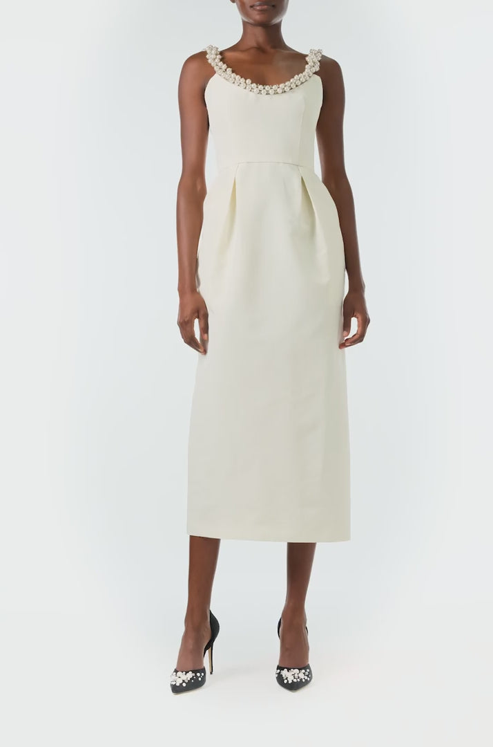 Monique Lhuillier Fall 2024 sleeveless, scoop neck cocktail dress with pearl embroidered neckline, low back, pockets, and natural waist seam - video.