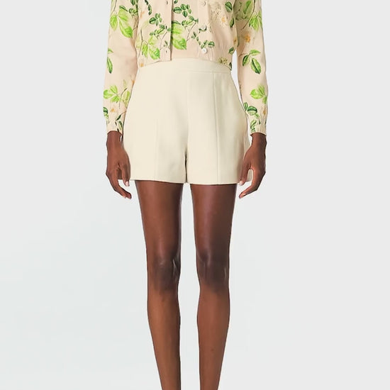 Monique Lhuillier Spring 2025 rose printed knit long sleeve cardigan with button center front closure in Bellini Multi - video.