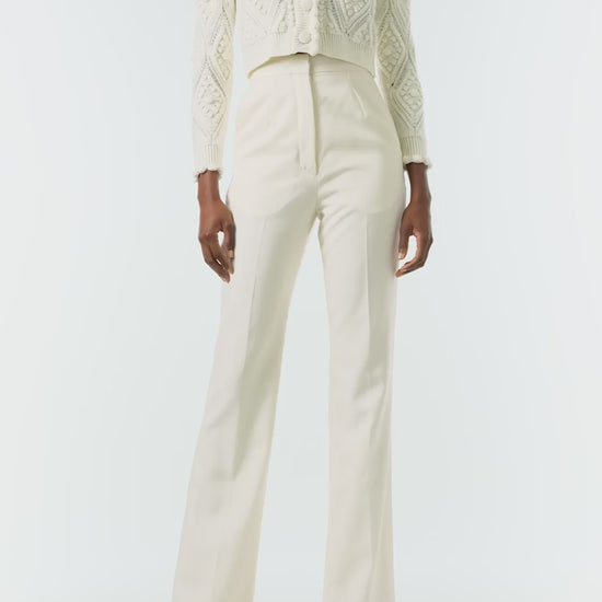 Monique Lhuillier Fall 2024 long sleeve, cropped bobble cardigan in Creme wool cable knit - video.