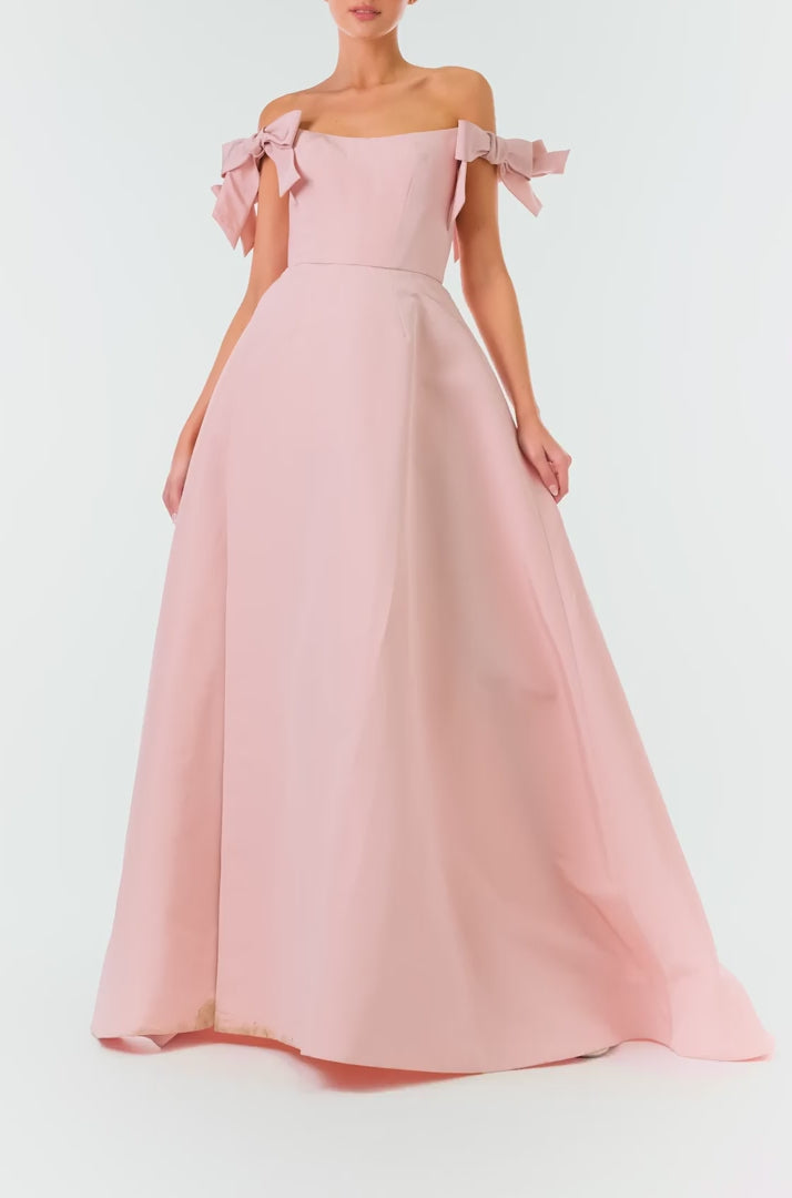 Monique Lhuillier Fall 2024 off the shoulder bow sleeve gown in pale blush faille with full skirt and high leg slit - video.