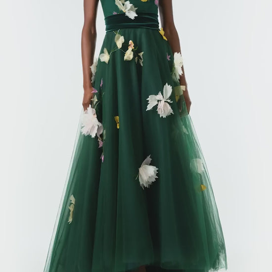 Monique Lhuillier Fall 2024 sleeveless, green tulle gown with floral embroidery, illusion neckline, full A-line skirt and velvet cummerbund at waist - video.