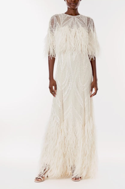 Monique Lhuillier Spring 2024 embroidered capelet gown with feathered trim.