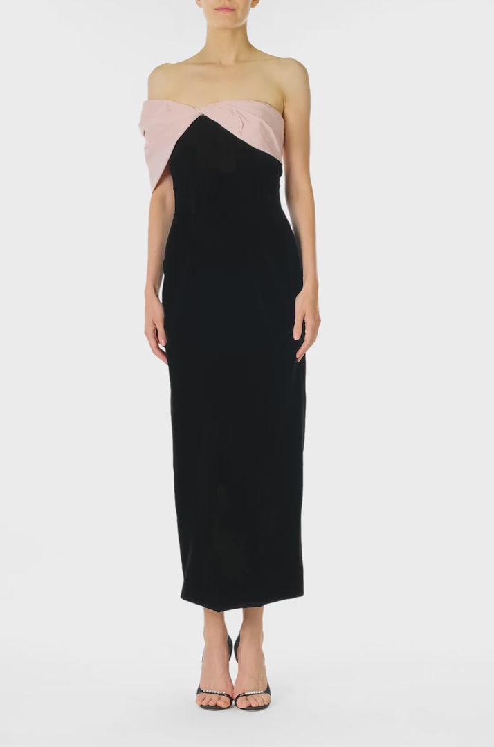 Monique Lhuillier Fall 2024 black velvet off the shoulder sheath dress with pale blush draped, asymmetric twist detail at neckline - video.