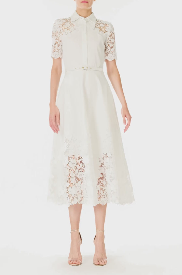 Monique Lhuillier Spring 2025 white cotton poplin dress with lace applique inserts, short sleeves, button down front bodice and belted waist - video.