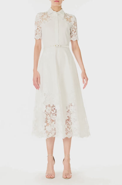 Monique Lhuillier Spring 2025 white cotton poplin dress with lace applique inserts, short sleeves, button down front bodice and belted waist - video.