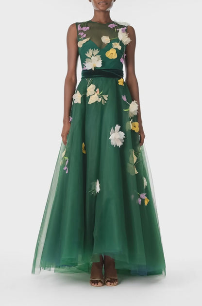 Monique Lhuillier Fall 2024 sleeveless, green tulle gown with floral embroidery, illusion neckline, full A-line skirt and velvet cummerbund at waist - video.