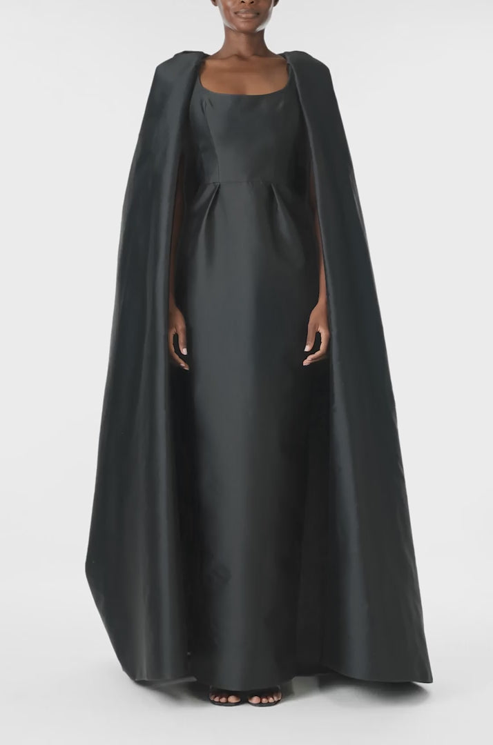 Monique Lhuillier Fall 2024 sleeveless, scoop neck column gown with integral cape in noir mikado fabric - video.