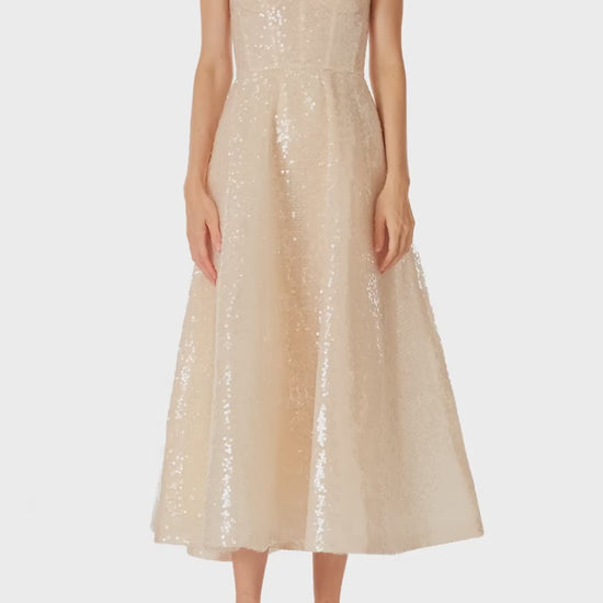 Monique Lhuillier Spring 2025 strapless, tea-length dress with sweetheart neckline in prosecco colored sequins - video.