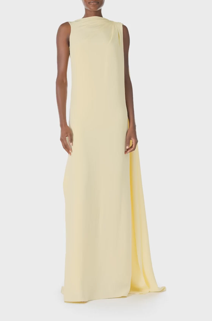 Monique Lhuillier Spring 2025 draped shoulder caftan gown with integral cape and side slit in limoncello yellow - video.