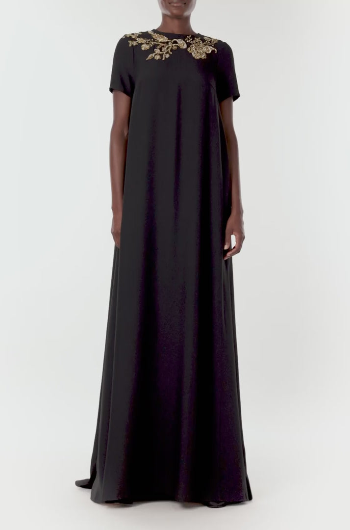 Monique Lhuillier black jewel neck, short sleeve caftan with gold embroidery.