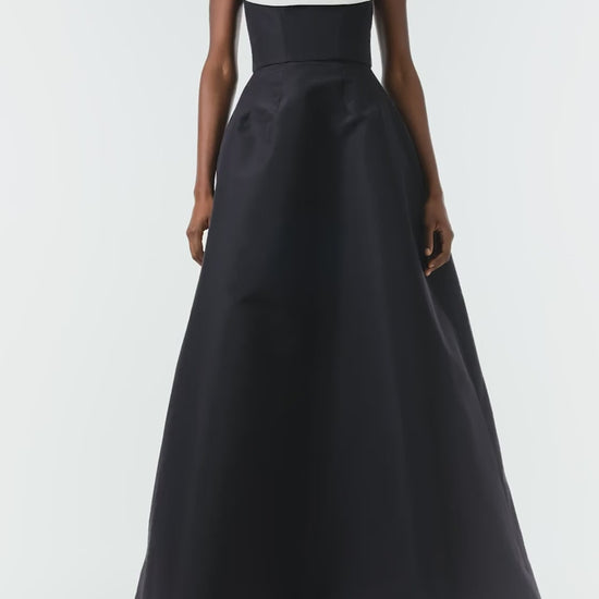 Monique Lhuillier Fall 2024 strapless ball gown with front-draped, contrasting neckline in noir/silk white faille fabric - video.