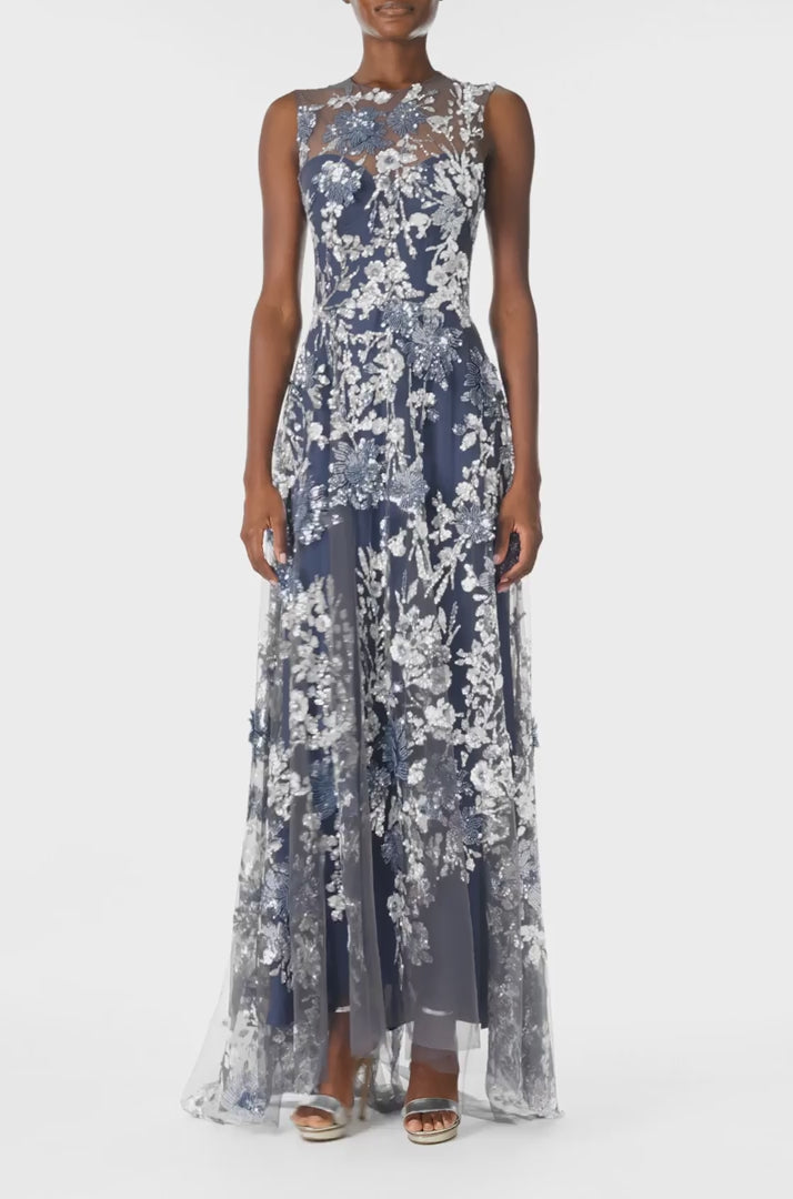 Monique Lhuillier sleeveless, sequin tulle gown with illusion neckline and slight high-low hem in navy multi colors - video.