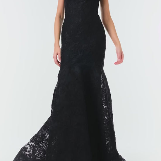 Monique Lhuillier Fall 2024 black lace, off-the-shoulder, draped gown with soft v-neck, spaghetti straps and caged trumpet skirt - video.