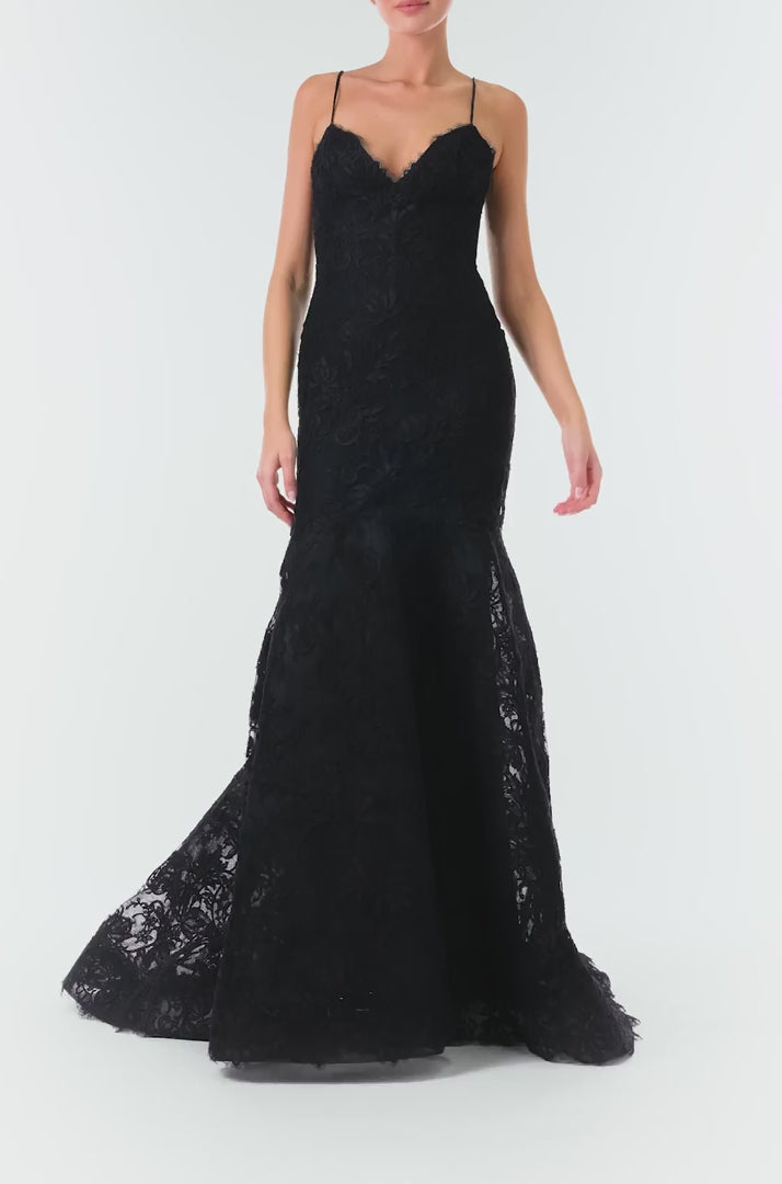 Monique Lhuillier Fall 2024 black lace, off-the-shoulder, draped gown with soft v-neck, spaghetti straps and caged trumpet skirt - video.