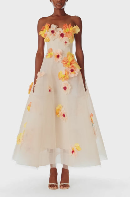 Monique Lhuillier Spring 2025 Strapless, Ecru colored tea-length dress with light boning in bodice and structured horsehair tulle skirt in cascading floral Poppy embroidery - video.