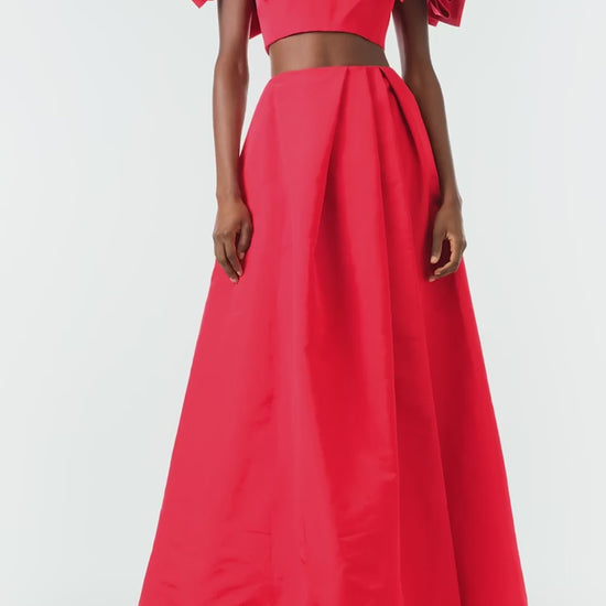 Monique Lhuillier Fall 2024 scarlet red faille pleated ballgown skirt with high front slit and pockets - video.