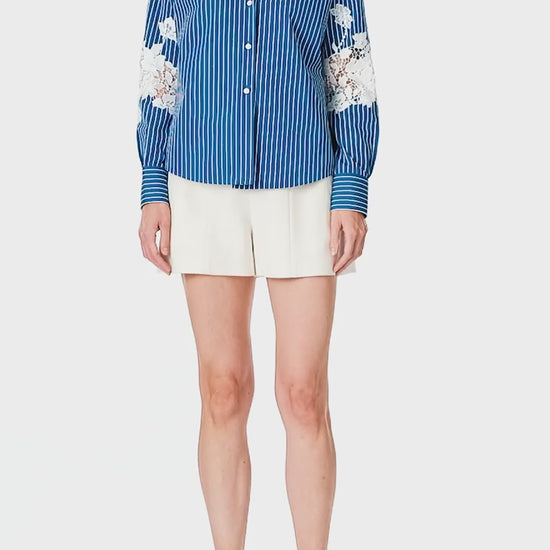 Monique Lhuillier Spring 2025 Long sleeve, button front collared striped shirt with lace detailing in Nautical Blue poplin with White lace details  - video.