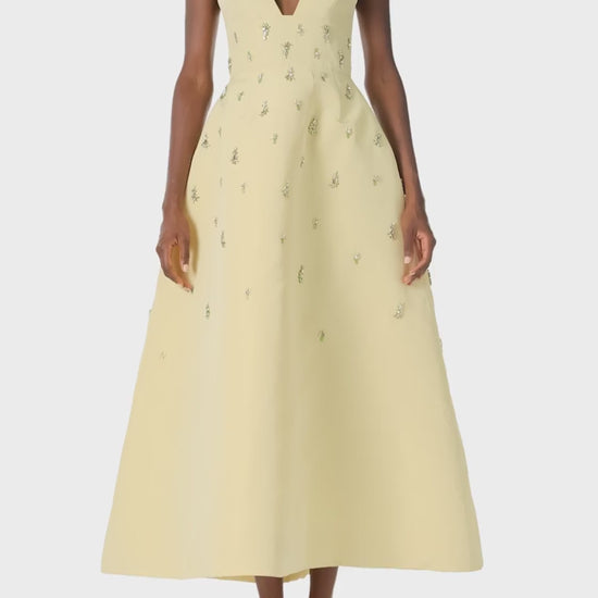 Monique Lhuillier Spring 2025 Embroidered cocktail dress with v-neckline and tea-length skirt  in Limoncello faille - video.