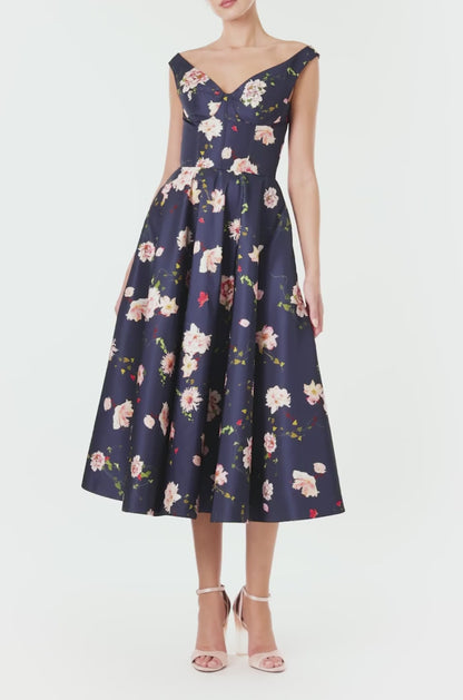 Monique Lhuillier navy floral midi dress with off the shoulder neckline, fit & flare skirt and pockets.