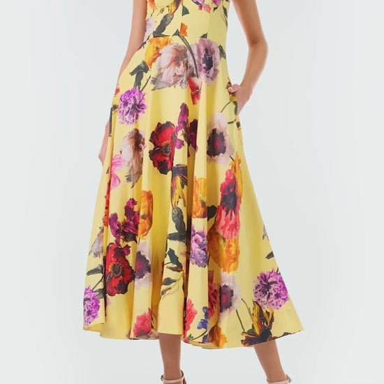 Monique Lhuillier Fall 2024 spaghetti strap, A-line cocktail dress with corseted bodice in yellow floral printed silk faille - video.