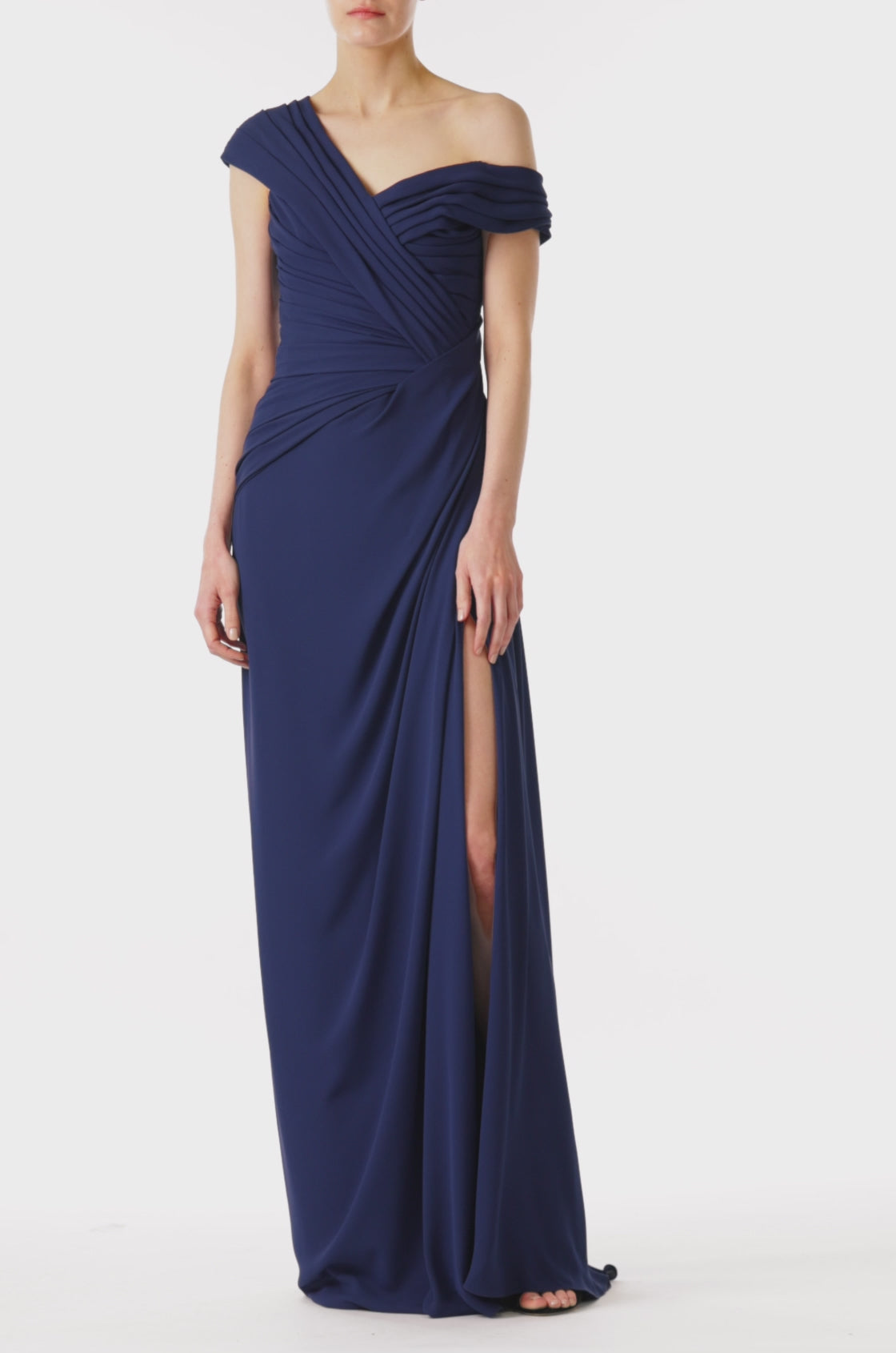 Monique Lhuillier navy gown with draped neckline and high leg slit in jersey chiffon fabric.